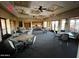 Spacious meeting room with tables, chairs, and large windows offering plenty of natural light for gatherings at 8377 S Mountain Air Ln, Gold Canyon, AZ 85118