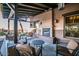 Covered outdoor patio with comfortable seating, fireplace, and serene views at 8377 S Mountain Air Ln, Gold Canyon, AZ 85118