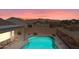 Inviting backyard pool featuring desert landscaping, an outdoor living space, and mountain views at 8377 S Mountain Air Ln, Gold Canyon, AZ 85118