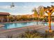 Community pool with mountain views, poolside seating, and desert landscaping at 8377 S Mountain Air Ln, Gold Canyon, AZ 85118