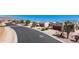 Charming street view featuring well-maintained desert landscaping, mature trees, and houses at 8377 S Mountain Air Ln, Gold Canyon, AZ 85118