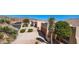 A street view showcases lush desert landscaping and houses with multiple car garages at 8377 S Mountain Air Ln, Gold Canyon, AZ 85118
