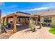 Residential backyard featuring a paved patio, shaded gazebo, and a small water fountain at 9728 E Pantera Ave, Mesa, AZ 85212