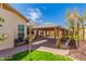 Beautiful backyard featuring a covered patio, lush landscaping, and a serene atmosphere at 9728 E Pantera Ave, Mesa, AZ 85212