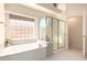 Modern bathroom with a soaking tub and glass-enclosed shower offers a spa-like experience at 9728 E Pantera Ave, Mesa, AZ 85212