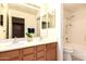 Bathroom boasting double sinks, wood cabinetry, and a shower with a tub combination at 9728 E Pantera Ave, Mesa, AZ 85212
