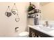 Charming powder room with decorative mirrors, floating shelves, and stylish fixtures at 9728 E Pantera Ave, Mesa, AZ 85212