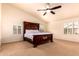 Spacious bedroom features a large bed with decorative headboard, and window shutters at 9728 E Pantera Ave, Mesa, AZ 85212