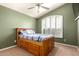 Charming bedroom featuring a wooden bed frame and a window with adjustable shutters at 9728 E Pantera Ave, Mesa, AZ 85212