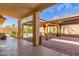 Open covered patio with ample space for seating, overlooking the lush backyard landscape at 9728 E Pantera Ave, Mesa, AZ 85212