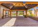 Spacious outdoor covered patio with brick pavers and lighting, ideal for relaxing and entertaining at 9728 E Pantera Ave, Mesa, AZ 85212