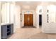 Bright entryway featuring tiled floors and a large, wooden double door at 9728 E Pantera Ave, Mesa, AZ 85212