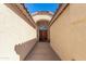 Inviting walkway leads to an elegant front entryway, featuring beautiful double doors and an arched entrance at 9728 E Pantera Ave, Mesa, AZ 85212