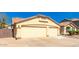 Spacious, two-car garage with neutral tone exterior and a well-maintained driveway at 9728 E Pantera Ave, Mesa, AZ 85212