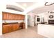Cozy kitchen featuring wooden cabinetry, a built-in desk, and easy access to other living areas at 9728 E Pantera Ave, Mesa, AZ 85212