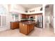 Well-lit kitchen showcasing wood cabinets, stainless steel appliances, and a functional center island at 9728 E Pantera Ave, Mesa, AZ 85212