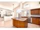 Open-concept kitchen featuring an island, stainless steel appliances, and ample natural light at 9728 E Pantera Ave, Mesa, AZ 85212