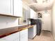 Well-equipped laundry room features modern appliances, ample counter space, and plenty of storage at 9728 E Pantera Ave, Mesa, AZ 85212