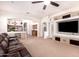 Open-concept living room featuring a TV, seamlessly connected to the kitchen area at 9728 E Pantera Ave, Mesa, AZ 85212