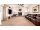 Comfortable living room with a fireplace, large TV, and plush leather sofa at 9728 E Pantera Ave, Mesa, AZ 85212