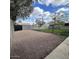Backyard area with gravel and decomposed granite surrounded by block fencing and mature landscaping at 1017 S Lola Ln, Tempe, AZ 85281