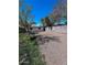 Backyard area with gravel and decomposed granite surrounded by block fencing and mature landscaping at 1017 S Lola Ln, Tempe, AZ 85281