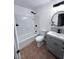 Bathroom with a shower-tub combo, gray vanity, tiled walls, and matching tile floor at 1017 S Lola Ln, Tempe, AZ 85281