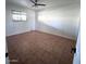 Bedroom with neutral walls, tiled floors, a ceiling fan, and a window at 1017 S Lola Ln, Tempe, AZ 85281