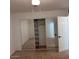 Bedroom featuring a large closet with mirrored doors, tiled floors and view of the rest of the room at 1017 S Lola Ln, Tempe, AZ 85281
