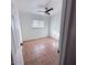 This bedroom features tiled floors, neutral walls, and a window at 1017 S Lola Ln, Tempe, AZ 85281