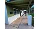 Side angle of covered front porch with decorative columns and a stylish front door at 1017 S Lola Ln, Tempe, AZ 85281