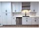 Updated kitchen featuring stainless steel appliances, modern faucet, and ample white cabinets for storage and style at 1017 S Lola Ln, Tempe, AZ 85281
