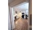Open kitchen view showcasing stainless appliances, white cabinetry, and a tiled floor at 1017 S Lola Ln, Tempe, AZ 85281