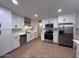 Bright kitchen with stainless steel appliances, ample cabinet space, and tiled floors at 1017 S Lola Ln, Tempe, AZ 85281