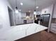 Bright renovated kitchen with quartz counters, stainless steel appliances and white cabinets at 1017 S Lola Ln, Tempe, AZ 85281