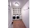Convenient laundry room with shelving, storage, and washer/dryer hookups at 1017 S Lola Ln, Tempe, AZ 85281