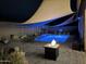 Nighttime view of the backyard pool and landscaping, illuminated by soft lighting at 10932 E Bella Via --, Mesa, AZ 85212