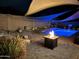 Beautiful backyard pool and patio illuminated at night, complete with a cozy fire pit at 10932 E Bella Via --, Mesa, AZ 85212