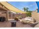 Backyard patio featuring a rock water feature, brick pavers, desert landscaping, and a large sun shade at 10932 E Bella Via --, Mesa, AZ 85212