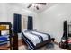 Bedroom with wood floors, a ceiling fan, a window with curtains, and a blue bedspread at 10932 E Bella Via --, Mesa, AZ 85212