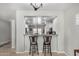 A bright dining room showcases a breakfast bar that offers a view into a modern kitchen at 10932 E Bella Via --, Mesa, AZ 85212