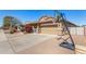 Home exterior with lovely curb appeal, blooming bushes, and a basketball hoop at 10932 E Bella Via --, Mesa, AZ 85212