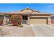 Charming home exterior showcasing a well-maintained front yard with a blooming bush and desert landscaping at 10932 E Bella Via --, Mesa, AZ 85212