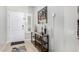 Well-lit foyer with tiled floor, console table with decor, and a view of the front door at 10932 E Bella Via --, Mesa, AZ 85212
