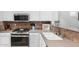 A well-equipped kitchen features stainless steel appliances, including a gas range, and custom backsplash at 10932 E Bella Via --, Mesa, AZ 85212
