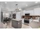 An expansive kitchen includes stainless appliances, a central island, and a connected dining area for casual meals at 10932 E Bella Via --, Mesa, AZ 85212