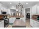 Bright, open kitchen with stainless steel appliances, central island, and seamless flow to dining and living areas at 10932 E Bella Via --, Mesa, AZ 85212