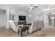 Comfortable living room with tiled floors, a ceiling fan, and a large television at 10932 E Bella Via --, Mesa, AZ 85212