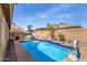 Inviting backyard pool area featuring lush landscaping, lounge chairs, and a covered patio at 10932 E Bella Via --, Mesa, AZ 85212