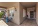 Inviting front porch with seating, textured walls, and decorative light fixtures at 10932 E Bella Via --, Mesa, AZ 85212